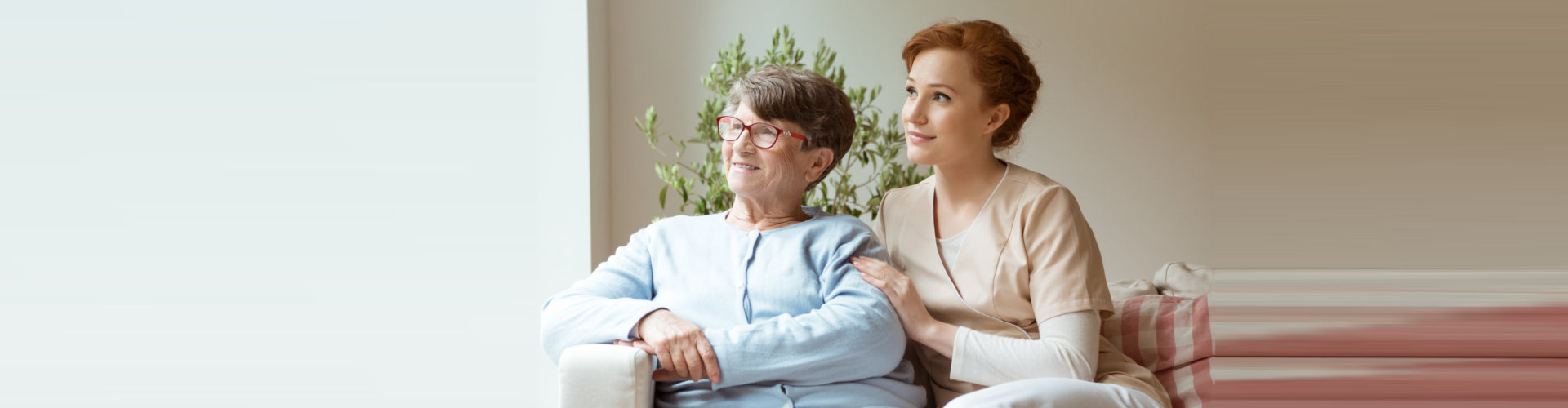 senior woman and caregiver sitting together